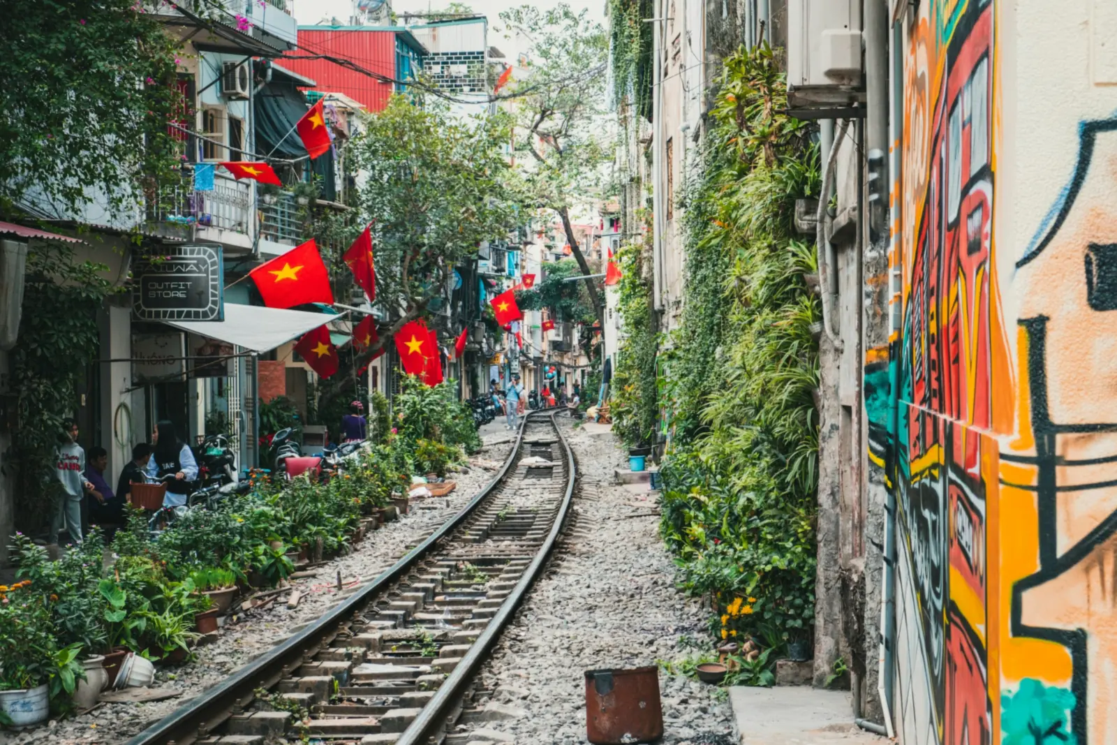 Hanoi's train street, a narrow lane along the railway hung with Vietnamese flags